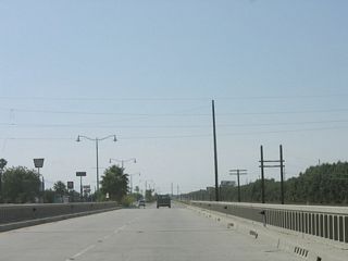 West of Clinton Street, Indio Boulevard crosses the Whitewater River on this 1956 bridge. The Whitewater River spans the length of the Coachella Valley and empties into the Salton Sea. A companion 1925 bridge carries the southbound (eastbound) traffic.