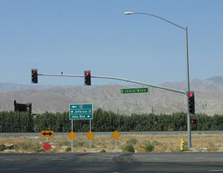 Northbound Jefferson Street at Indio Boulevard (Historic U.S. 60-70-99). Changes made by 2017 extended Jefferson Boulevard northwest over Interstate 10 to connect the two previously separate segments of the arterial.