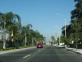Lush landscaping lines both the parkway strip and median of Valley Boulevard beside Colton High School. Valley Boulevard is former U.S. 70-99 in Colton.