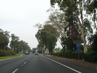A turf median separates the roadways along Centre City Parkway between 13th and 9th Avenues. 9th Avenue west connects Business Loop I-15 with Interstate 15 across from Auto Park Way.