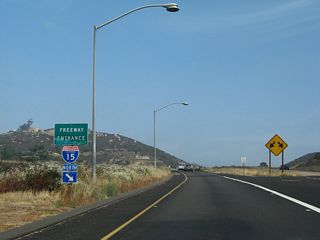 Business Loop I-15 ends along the entrance ramp to Interstate 15 north by the Merriam Mountains.