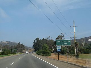 A San Diego Gas & Electric 230kV power line crosses over the expressway along Business Loop I-15 ahead of Country Club Lane.