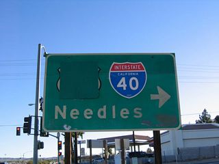 The previous guide sign at the entrance ramp for I-40 east from E Main Street (Business Loop I-15) was one of a handful of reflective signs placed in the 1960s. The sign was old enough that it originally displayed a U.S. 66 shield.