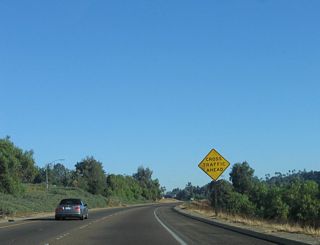 Business Loop I-15 (Centre City Parkway) separates from I-15 north with limited access for 0.6 miles.