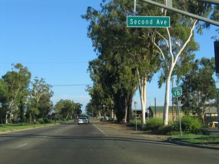 San Diego County Route S-6 (Second Avenue) leads northeast to Valley Center and Palomar Mountain. A reassurance shield for Business Loop I-15 is posted after the intersection.