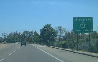 Business Loop I-15 (Centre City Parkway) advances south from the traffic light at Decatur Way to a half cloverleaf interchange with SR 78 (Ronald Packard Parkway) westbound.