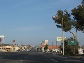 E Main Street proceeds northwest beyond Barstow Mall to a parclo interchange (Exit 184 B) with Interstate 15 at Roberta Street.