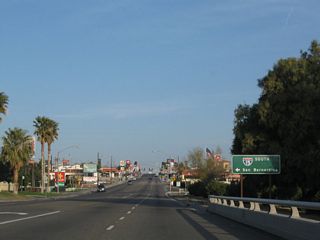 Business Loop I-15/Historic U.S. 66 (E Main Street) cross Interstate 15 ahead of the southbound entrance ramp to San Bernardino and Los Angeles.