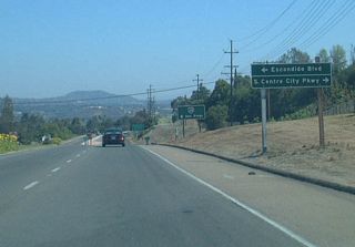 An access road links Business Loop I-15 with the expressway frontage road system, S Centre City Parkway and S Escondido Boulevard, prior to Interstate 15.