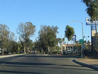 A Business Loop I-15 reassurance shield stands along Centre City Parkway south of Washington Avenue.