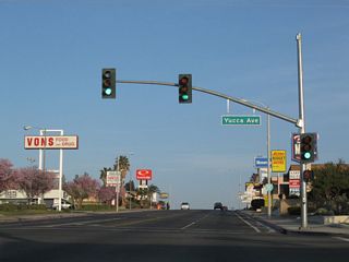 Westbound Business Loop I-15 and Historic U.S. 66 (Main Street) intersect Yucca Avenue by three shopping centers. Yucca Avenue runs north to connect with Riverside Drive west to the U.S. 66 Museum and historic train station.