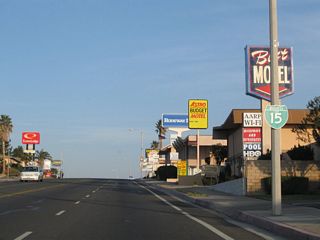 The Business Loop I-15 shield posted along westbound Main Street after Yucca Avenue was removed by 2022.