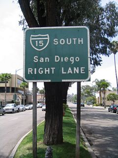 Removed by 2018, this guide sign for Interstate 15 stood in the median of Grand Avenue west of Escondido Boulevard in Downtown Escondido. It referenced Business Loop I-15 north to Valley Parkway (CR S-6) west.