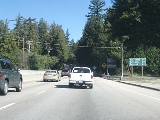 This mileage sign provides the distance to Los Gatos (14 miles), San Jose (27 miles), and Oakland (69 miles). For the next ten or so miles, California 17 will cross the Santa Cruz Mountains. Speed limits are reduced on this winding stretch of expressway. Full freeway standards will not be seen again until the California 9 interchange in Santa Clara County.