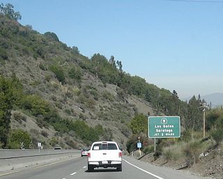 The next three exits along northbound are a left turn to the frontage road; Exit 19, Santa Cruz Avenue; and Exits 20A-B, California 9. The first sign is for Exit 20B, which follows Saratoga Avenue east to Los Gatos Boulevard north to downtown Los Gatos and Exit 20A, which connects to California 9/Saratoga Avenue south (west) to Saratoga.