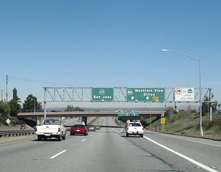 The next exit along California 17 north is Exit 22, California 85. This is a collector distributor lane arrangement, so through traffic may use this off-ramp. The aforementioned truck restrictions on California 85 were placed as a condition of allowing this freeway to be built. Taking California 85 north is one way to reach San Francisco and other peninsula destinations from California 17 north.