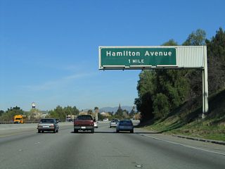 The next exit along California 17 north is Exit 25, Hamilton Avenue (note sign replacement and new location in 2008). Use Hamilton Avenue west through northern Campbell; exit east into the city of San Jose. After this interchange, California 17 enters the city of San Jose, which is home to 894,943 people as of the 2000 Census. Founded on November 29, 1777, and incorporated on March 27, 1850, San Jose is the third largest city in California (behind Los Angeles and San Diego). San Jose consists of 178.2 square miles and sits at an elevation of 85 feet. Rainfall in San Jose is much less than San Francisco due to its location at the south end of the San Francisco Bay and enclosure within mountains. The average annual precipitation is 14.4 inches.