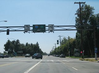 Westbound 30th Street approaches California 18/Waterman Avenue. Turn left for Waterman Avenue south or right for California 18/Waterman Avenue north. A slip ramp here also connects to California 210 (Foothill Freeway) west to Interstate 215 (the sign shows California 30, which has since been renumbered as California 210).
