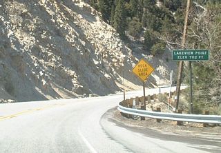 California 18 changes cardinal directions after the California 138 interchange. This view is found along eastbound California 18 at Lakeview Summit (el. 7,112 feet) just after the California 330 junction. California 18 is known as the "Rim of the World Highway" for a good reason!