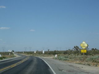 California 18 (Palmdale Road) continues east through an area subject to flooding.