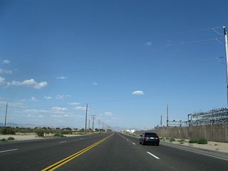 Continuing east, California 18 proceeds through western Victorville and skirts the northern edge of the unincorporated Mountain View Acres residential development. The city of Victorville had a population of 115,903 as of the 2010 Census and is located in the Victor Valley (through which the Mojave River runs). The city incorporated on September 21, 1962, and it sits at an elevation of 2,726 feet. This series of pictures follows California 18 east as it meets Emerald Road, Diamond Road, and Cobalt Road (signalized intersection).