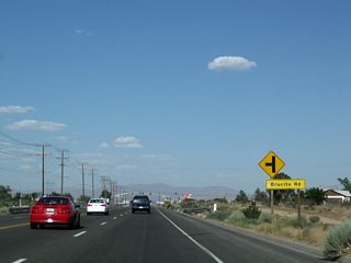 Eastbound California 18 meets Brucite Road and Amethyst Road, then passes under a pair of Los Angeles Department of Water and Power lines as well as a 500kV Southern California Edison/Los Angeles Department of Water and Power connector line that links a LADWP substation north of here with a Southern California Edison substation at Lugo near Hesperia.