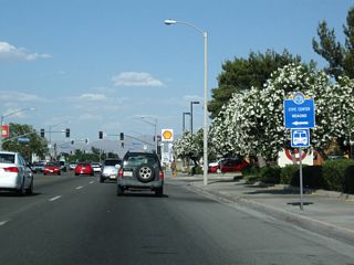 The next traffic signals along California 18 east are with Kentwood Boulevard and Park Avenue. Turn left to the Mojave Desert Air Quality Management offices as noted on this trailblazer sign.