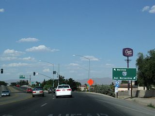 Eastbound California 18 meets Interstate 15 almost immediately thereafter. The first right turn is the on-ramp to Interstate 15 south to San Bernardino, Los Angeles, and San Diego. Continue ahead for the second right onto Interstate 15 north and California 18 east to Lucerne Valley.