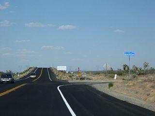 Eastbound California 18 meets 263rd Street East. The daytime headlight safety requirement ends soon after this intersection.