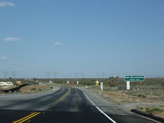 Eastbound California 18 leaves Los Angeles County and enters San Bernardino County. The state route changes names from Pearblossom Highway to Palmdale Road at the county line.