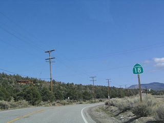 This California 18 reassurance marker is located along northbound as the highway skirts the northwestern shore of the dried-up lake.