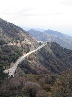 From a vantage point along the old California 18 grade from Crestline south to San Bernardino, visitors can see a view of one of the most closely spaced interchanges in California. As noted earlier, California 18 and California 138 interchange is located south of Crestline. This is a trumpet interchange, which is clearly seen by the interchange configuration here. It may be the only kind of interchange that might work in such a close environment with tight turns and steep grades.