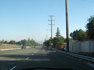 Now at the bottom of the hill, a California 18 south reassurance shield is posted after the Sierra Way/California 18 Business split.