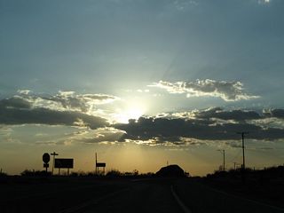 Westbound California 18 meets Bear Valley Road at this cutoff. Turn left for Bear Valley Road west to Interstate 15 and Hesperia. Proceed northwest on California 18 to Apple Valley and Victorville.