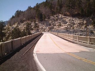 Views of the Big Bear Lake dam and bridge as seen looking west along California 18. There was not much traffic, mostly because these pictures were taken during the spring, which is the transitional season between the winter skiing season and the summer boating season.