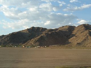 Rabbit Springs Dry Lake is easy to identify with its lack of vegetation and development.