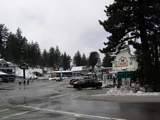 After a late season snow storm, this picture shows westbound California 18 as it passes through Running Springs just after the California 330 south split. The highway veers to the right as it passes through town.