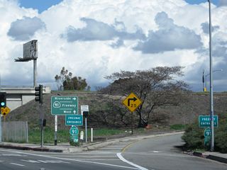 The guide sign for California 91 advises of California 91 east to Riverside and California 91 ... west. No control city is provided. The westbound control city for California 91 tends to be "Beach Cities," but some signs only show the cardinal direction. This most likely because California 91 serves several cities at its west end, with no particular city larger than the others.