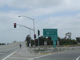 Shortly thereafter, northbound Studebaker Road meets the right turn to California 22 east to Interstate 605 north to Duarte, Interstate 405 north to LAX and Santa Monica, Interstate 405 south to Irvine and San Diego, and California 22 east to Garden Grove and Orange. Continue straight ahead to connect to California 22 (Seventh Street) west to Long Beach.