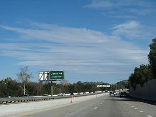 Northbound California 23 (Moorpark Freeway) approaches Exit 14, Janss Road in Thousand Oaks. A widening project to add a third lane was nearly complete by 2008. All of these approach signs have been replaced with reflective signs with the exit number.