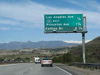 Another mileage sign provides the distance to the next four exits along both California 23 (Moorpark Freeway) north and California 118 (Ronald Reagan Freeway) east: Exit 20A, California 118 (Los Angeles Avenue) west and California 23 north to Fillmore; Exit 20B, California 118 (Simi Valley / Ronald Reagan Freeway) east to Simi Valley and Los Angeles; Exit 19A, Princeton Avenue; and Exit 19B, Collins Drive.