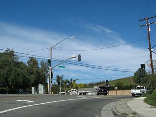 Northbound California 23/Walnut Canyon Road approaches Casey Street, which travels west toward Walnut Canyon School. Two sets of signs for Casey Street are posted on the traffic signal mast arms since the intersection is located on a somewhat blind curve.