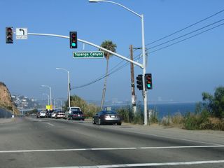 Southbound California 1 (Pacific Coast Highway) approaches California 27 (Topanga Canyon Boulevard) in the city of Malibu within a short distance of the beach.