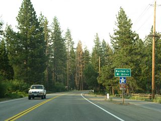 The next left turn connects eastbound California 28 to Burton Creek Drive north to the county sheriff station and courthouse annex; Burton Creek Drive is not a through street.