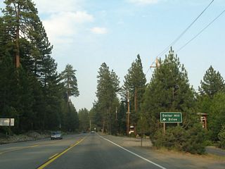 Eastbound California 28 approaches Dollar Hill Drive, which leads into a small residential area.