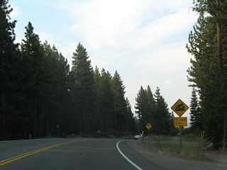 In one mile, California 28 will descend on a steep grade (over seven percent).