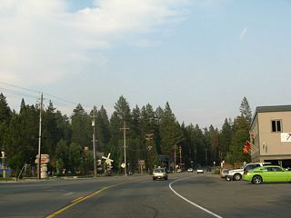 A few shops and restaurants line California 28 in Carnelian Bay. Ahead is the intersection with Carnelian Woods Avenue.
