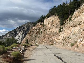 Along northbound California 39, the dangerous rocks that might fall are on the right side, while the precipitous cliff down is on the left side.