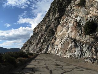 The former state highway is strewn with rocks and other debris.