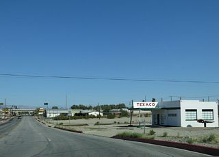 Needles Highway turns east into the Needles street grid at Arch Street and T Streets.